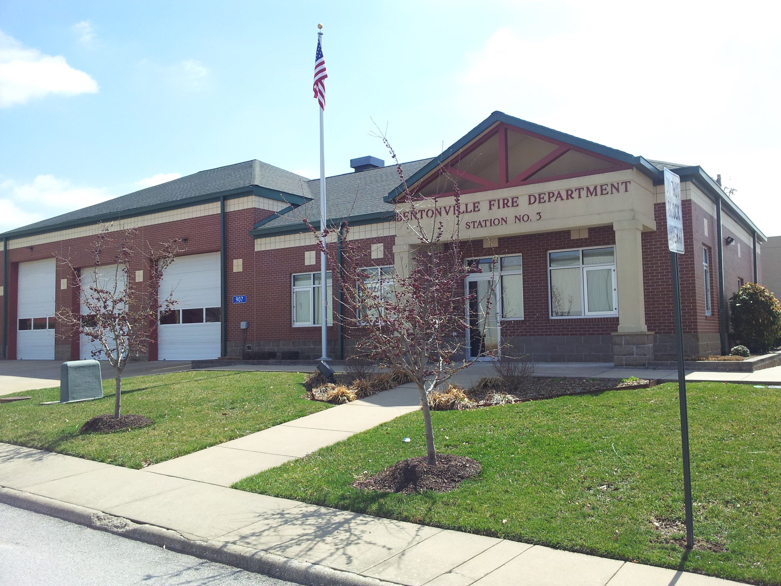 Facade of Station 3 with lawn and sidewalk and garage