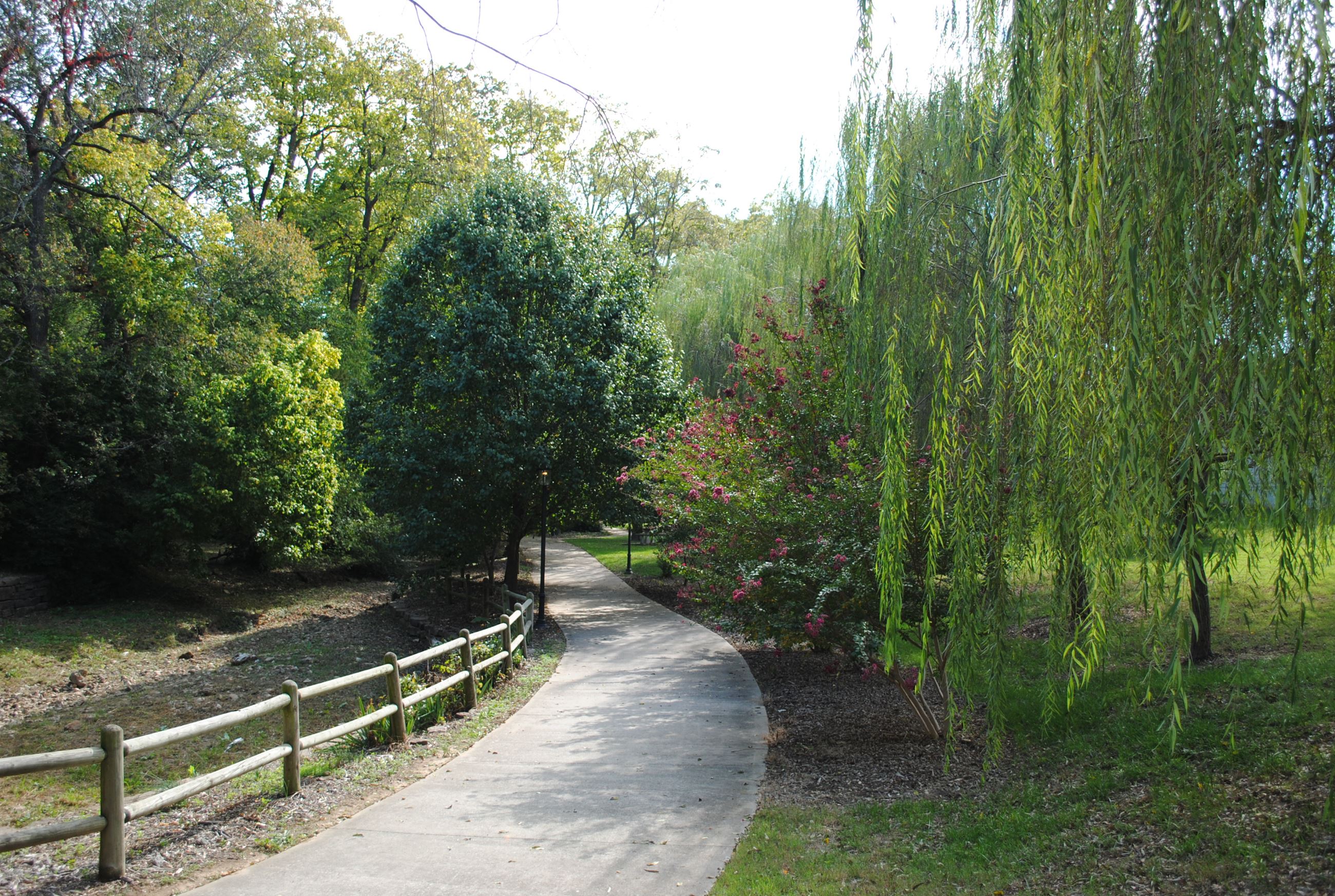 Town Branch Park image of tree lined paved sidewalk and fence