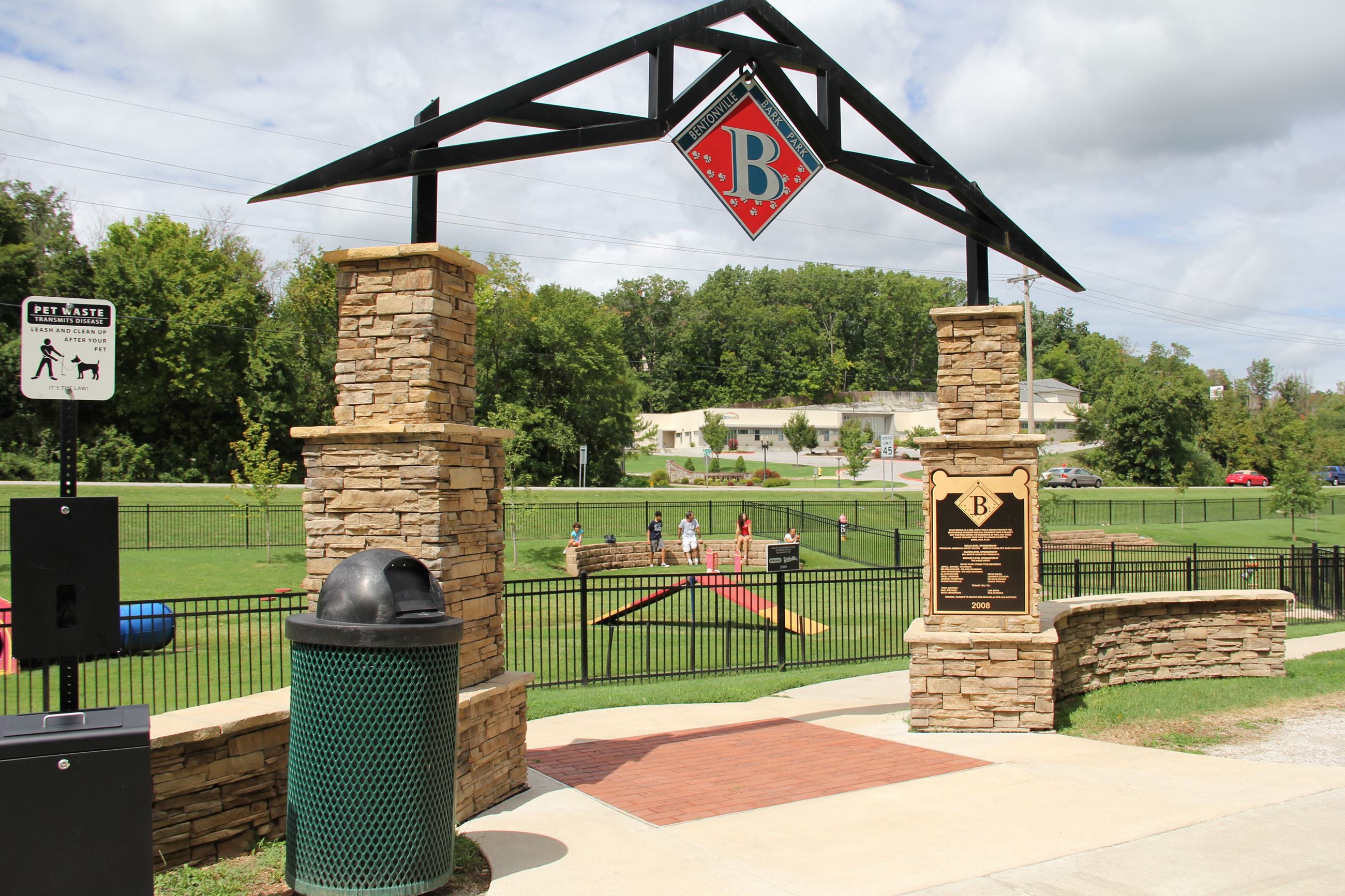 Bark Park Image of entrance gate and fenced field in background