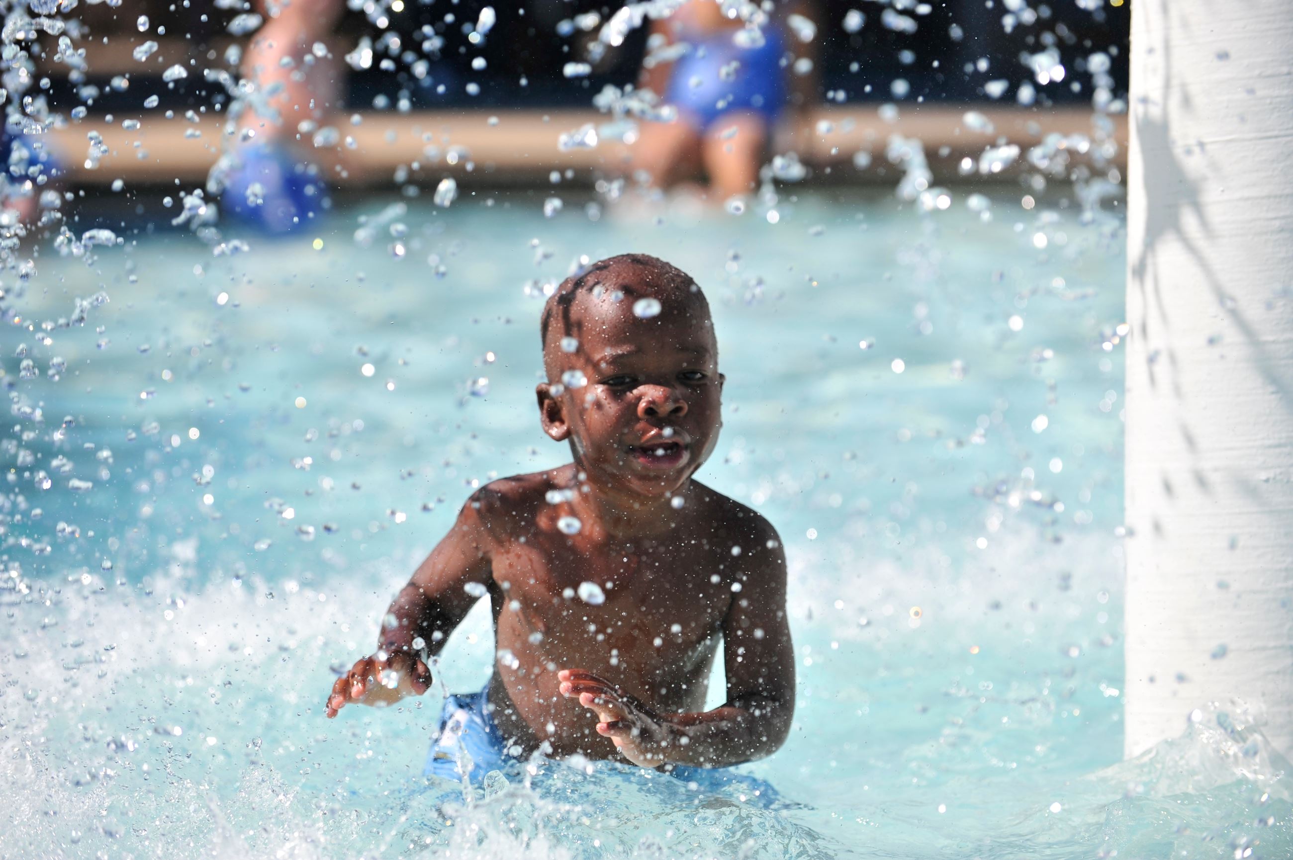 Child splashing in pool